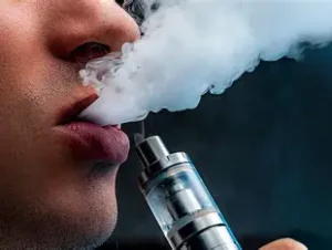 Hand wrapping a vape mod with ice pack in thin towel for summer vape cooling